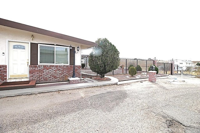 exterior space featuring brick siding and fence