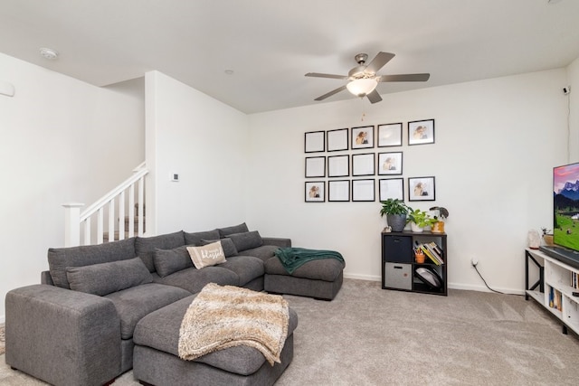 living area featuring a ceiling fan, carpet flooring, and baseboards