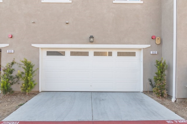 garage with concrete driveway