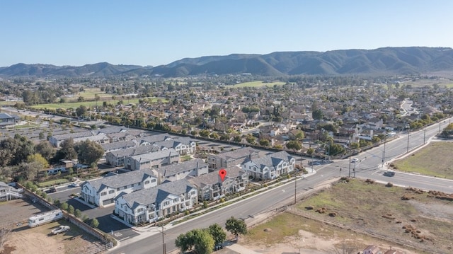 drone / aerial view featuring a residential view and a mountain view