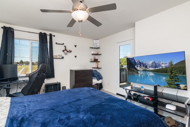 bedroom featuring ceiling fan, access to outside, and multiple windows