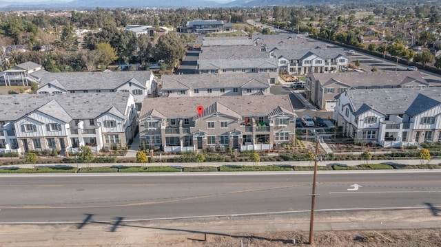 drone / aerial view featuring a residential view and a mountain view