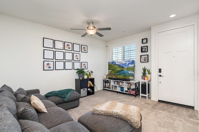 carpeted living room with a ceiling fan and recessed lighting