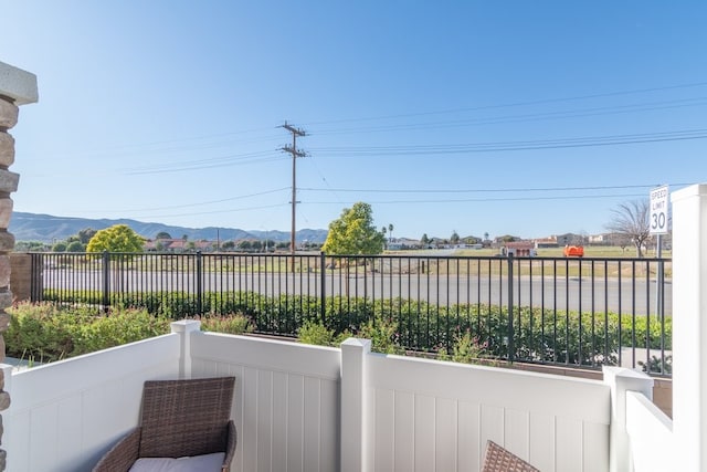 view of patio featuring fence and a mountain view