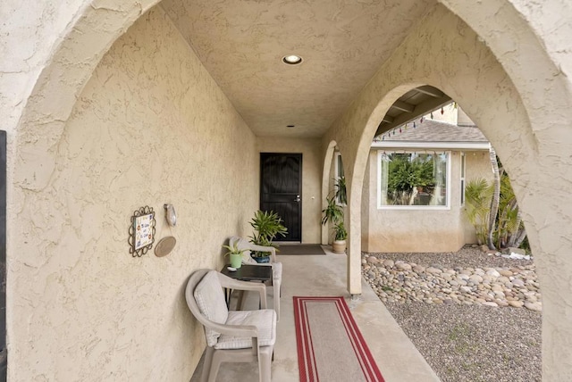 doorway to property featuring stucco siding