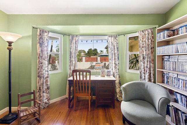 interior space with baseboards and wood finished floors