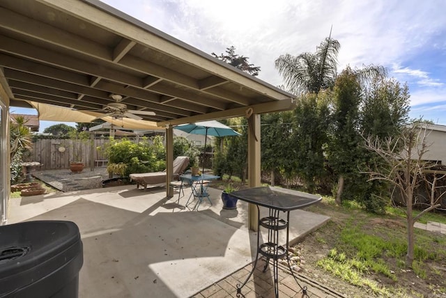 view of patio / terrace with fence and a ceiling fan