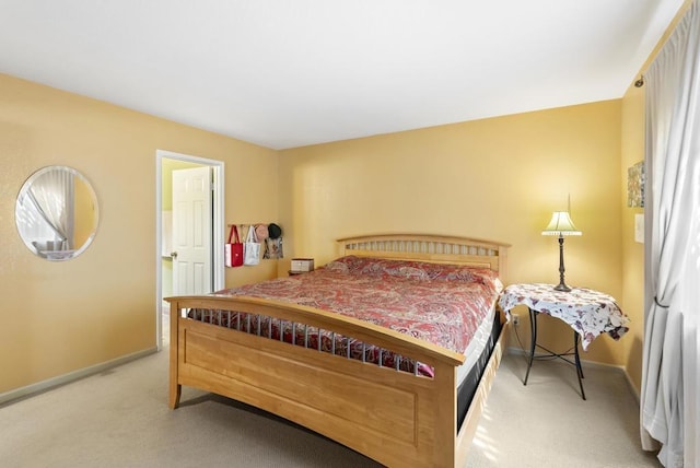 bedroom featuring carpet and baseboards