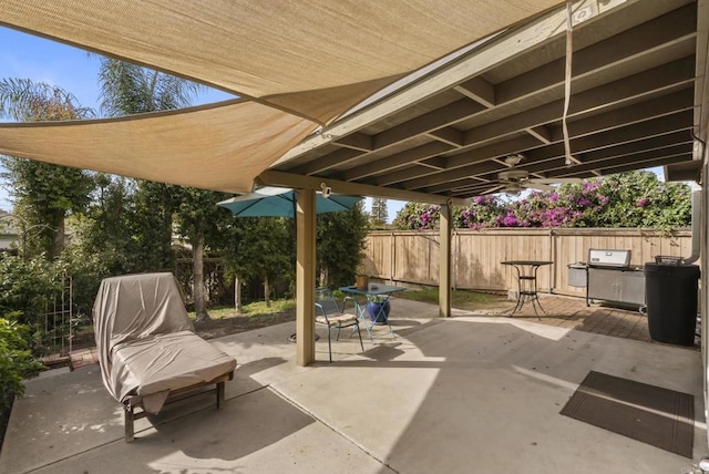 view of patio featuring grilling area and fence