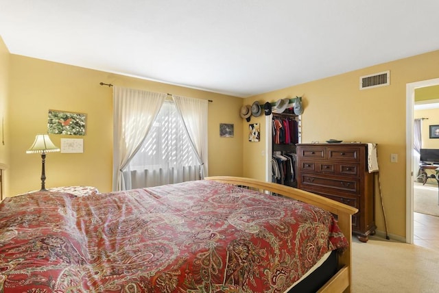 bedroom featuring carpet floors and visible vents