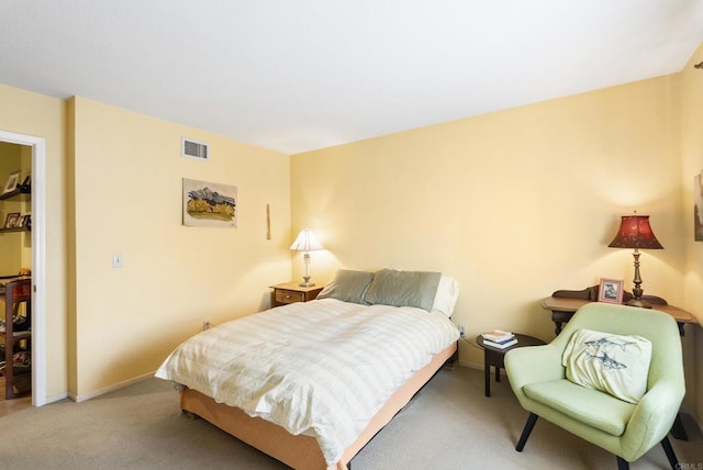 carpeted bedroom featuring baseboards and visible vents