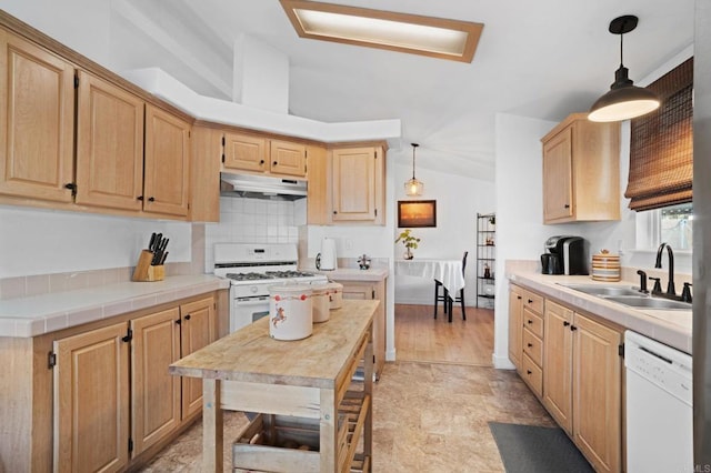 kitchen featuring lofted ceiling, light brown cabinets, under cabinet range hood, white appliances, and a sink