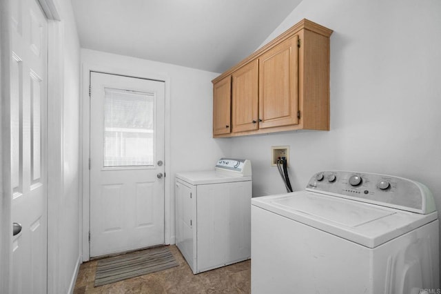 laundry area with independent washer and dryer and cabinet space