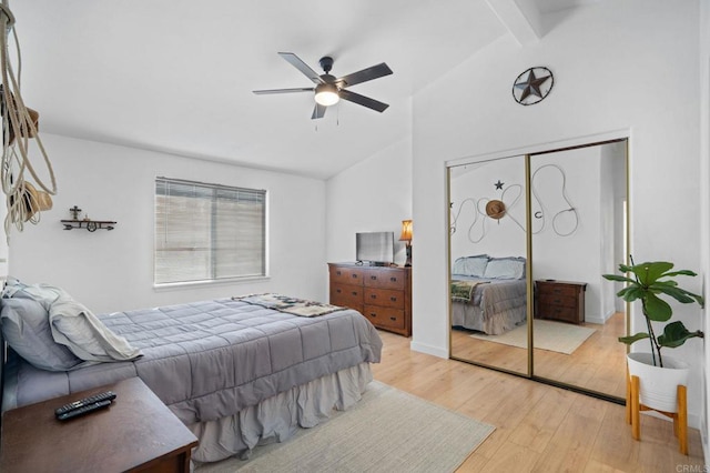 bedroom featuring vaulted ceiling with beams, light wood-style floors, and ceiling fan