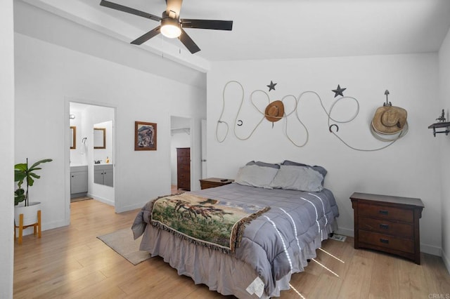 bedroom featuring light wood-type flooring, vaulted ceiling, and baseboards