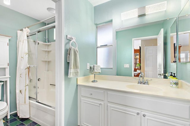 bathroom featuring vanity, toilet, and bath / shower combo with glass door