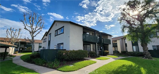 exterior space featuring a lawn and stucco siding