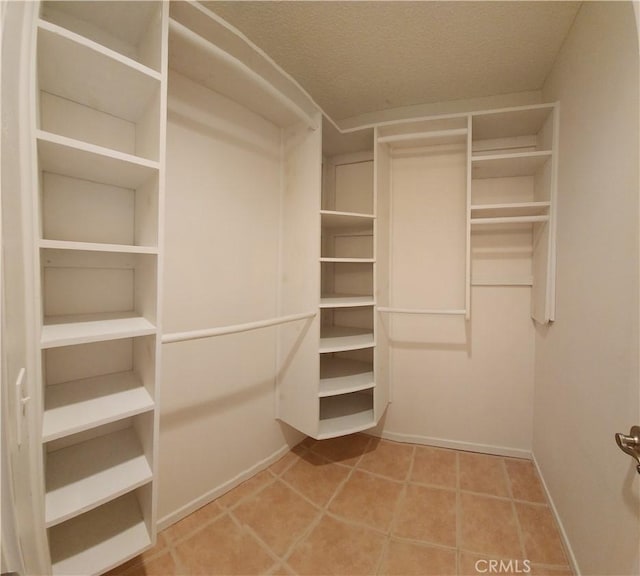 walk in closet featuring tile patterned flooring