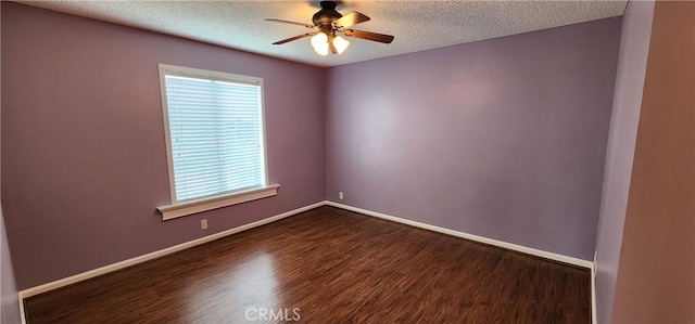 spare room with dark wood-style floors, ceiling fan, a textured ceiling, and baseboards