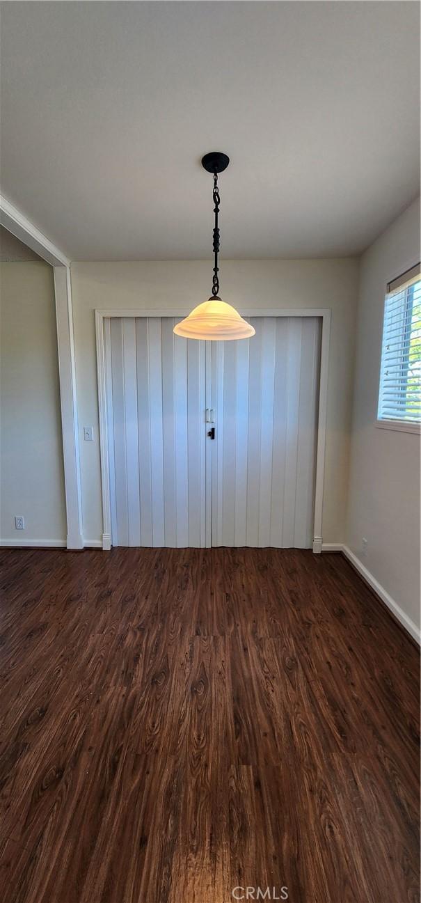 23230 Orange Ave Unit 2, Lake Forest, CA 92630 - empty room with dark wood-style floors and baseboards