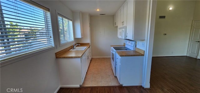 23230 Orange Ave Unit 2, Lake Forest, CA 92630 - kitchen with white appliances, a sink, white cabinetry, baseboards, and light tile patterned floors