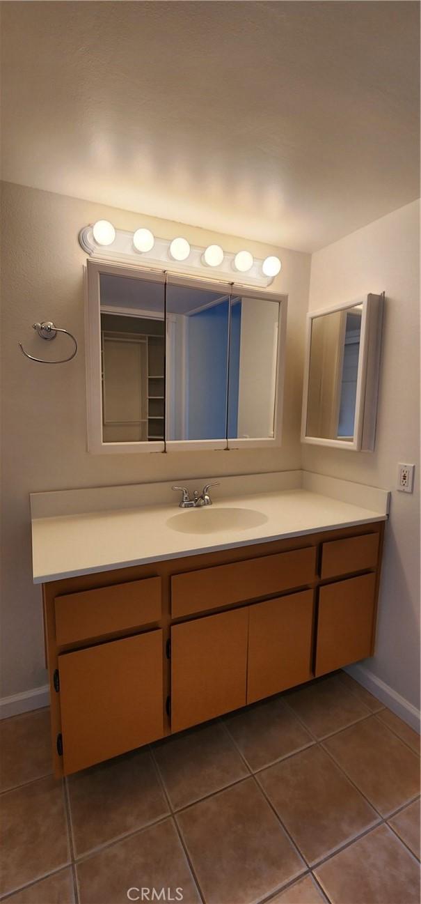 23230 Orange Ave Unit 2, Lake Forest, CA 92630 - bathroom featuring tile patterned floors, vanity, and baseboards
