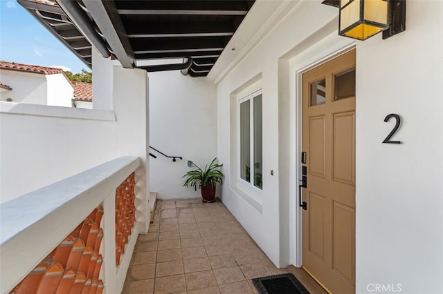 property entrance featuring visible vents and stucco siding