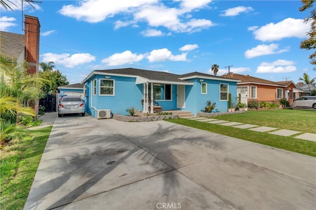 view of front facade with a front lawn, concrete driveway, and stucco siding