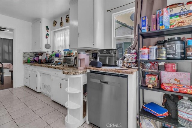 kitchen featuring light tile patterned floors, light stone counters, white cabinets, dishwasher, and tasteful backsplash