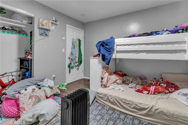 bedroom featuring baseboards and wood finished floors