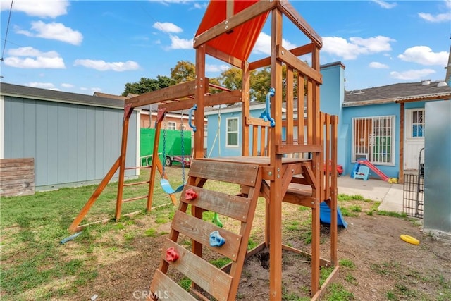 view of jungle gym with fence and a yard