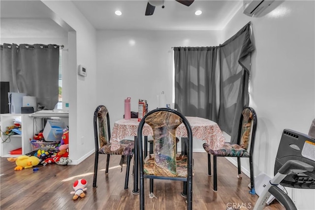 dining space featuring baseboards, a ceiling fan, wood finished floors, an AC wall unit, and recessed lighting