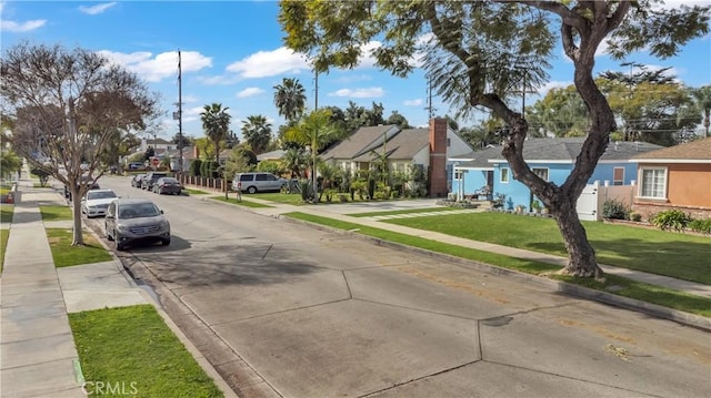 view of street with curbs, sidewalks, and a residential view