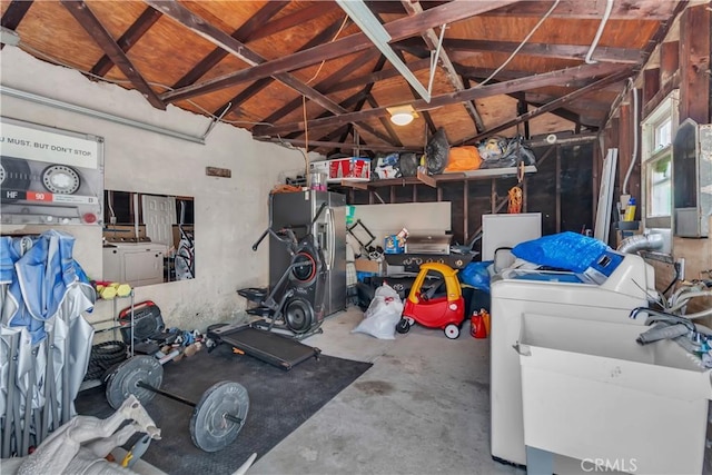 garage featuring a sink and washer and dryer