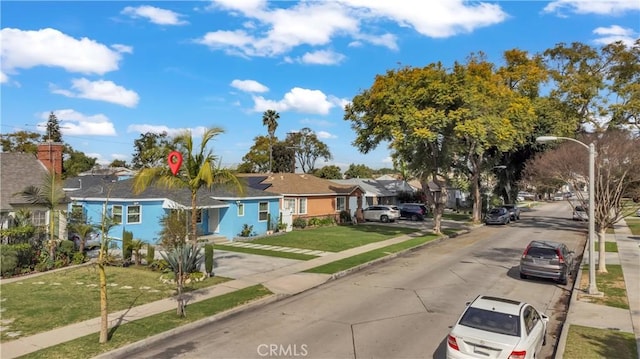 view of front of property featuring a front lawn and a residential view