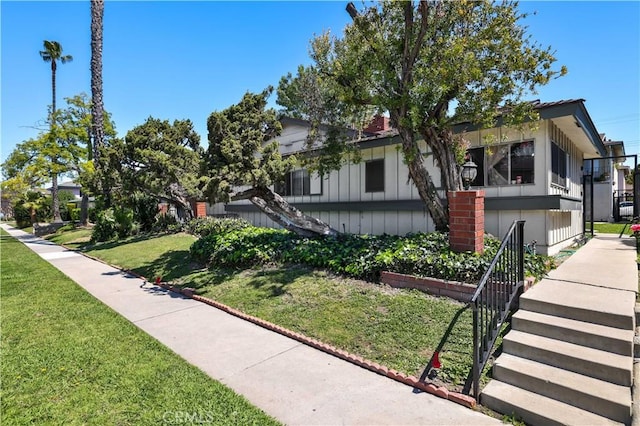 view of front of home with a front yard and stairs