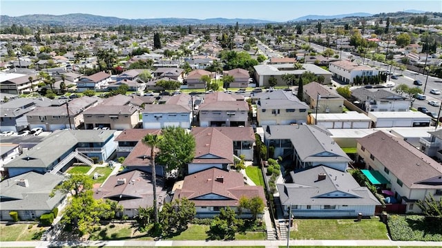 birds eye view of property with a mountain view and a residential view