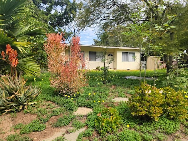 view of front of house with fence and stucco siding