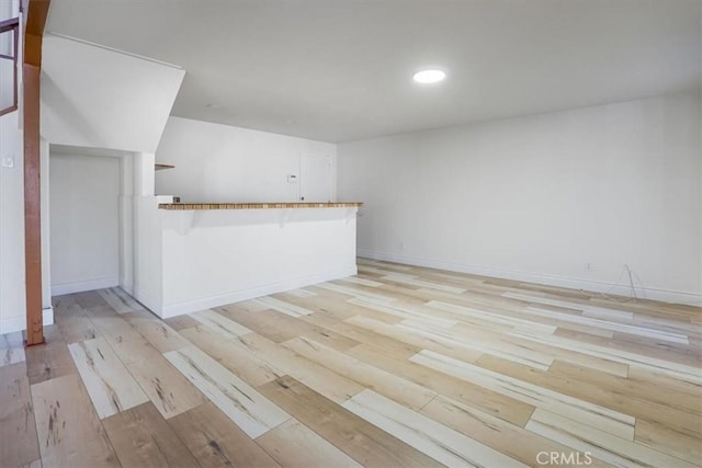 unfurnished room featuring light wood-type flooring, baseboards, and recessed lighting