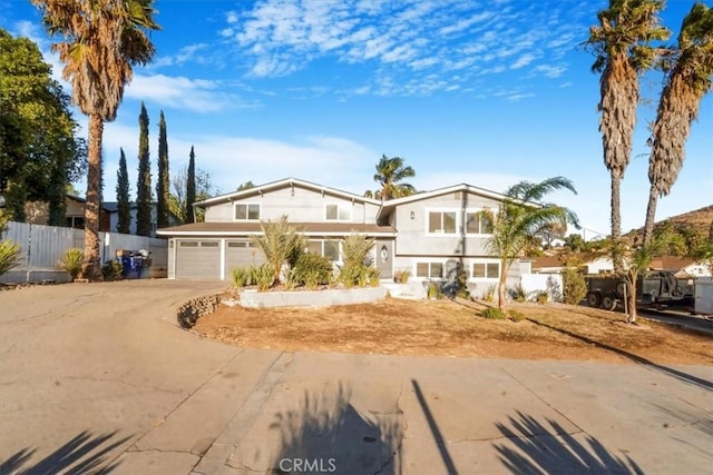 view of front of house with driveway and fence