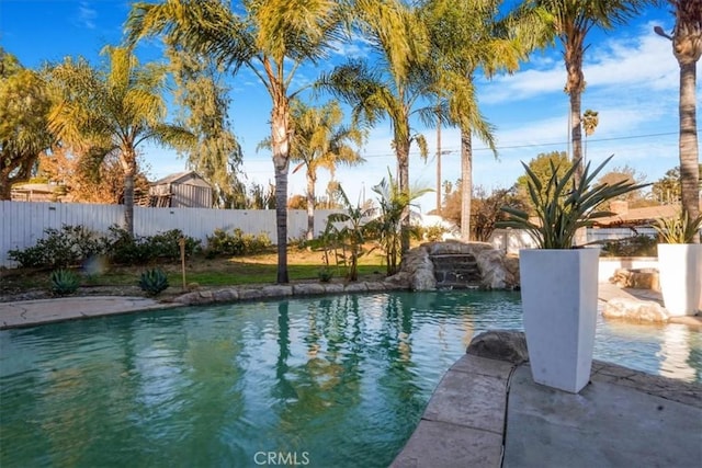 view of pool with a fenced backyard