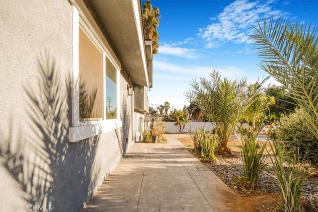 view of home's exterior featuring a patio area, fence, and stucco siding