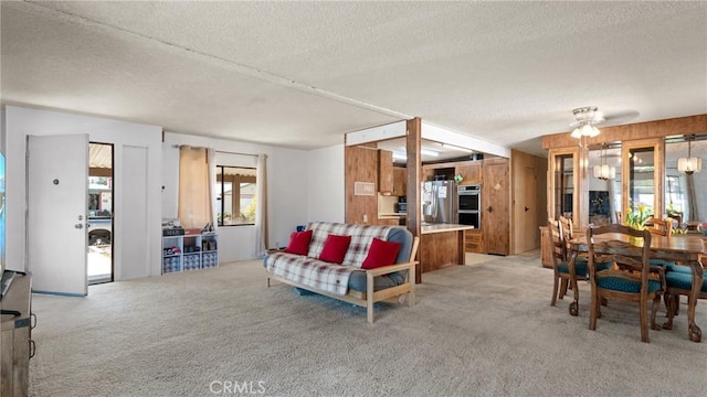 living room featuring a textured ceiling and light colored carpet