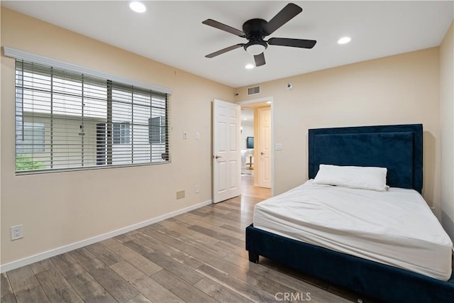 bedroom with recessed lighting, visible vents, ceiling fan, wood finished floors, and baseboards