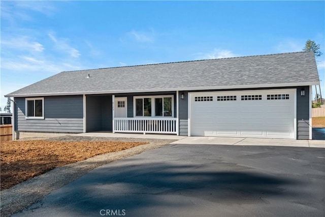 single story home featuring driveway, a porch, roof with shingles, and an attached garage