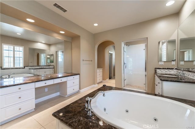 bathroom featuring recessed lighting, a sink, visible vents, tile patterned floors, and a tub with jets