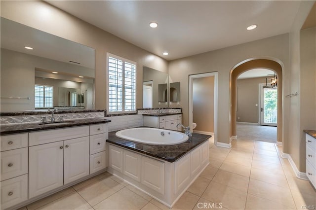 full bathroom featuring tile patterned flooring, two vanities, a sink, and recessed lighting