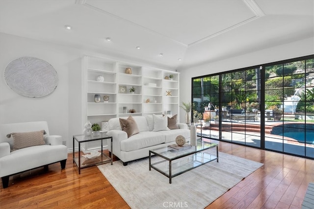 living area featuring recessed lighting, hardwood / wood-style flooring, and a healthy amount of sunlight