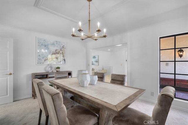 dining area featuring a chandelier, crown molding, baseboards, and light carpet