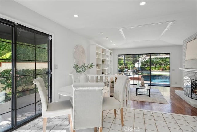 dining room featuring a fireplace, tile patterned floors, and recessed lighting